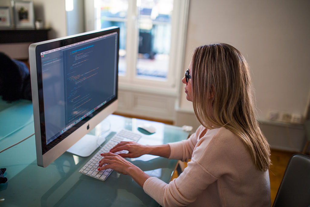 woman at computer writing code