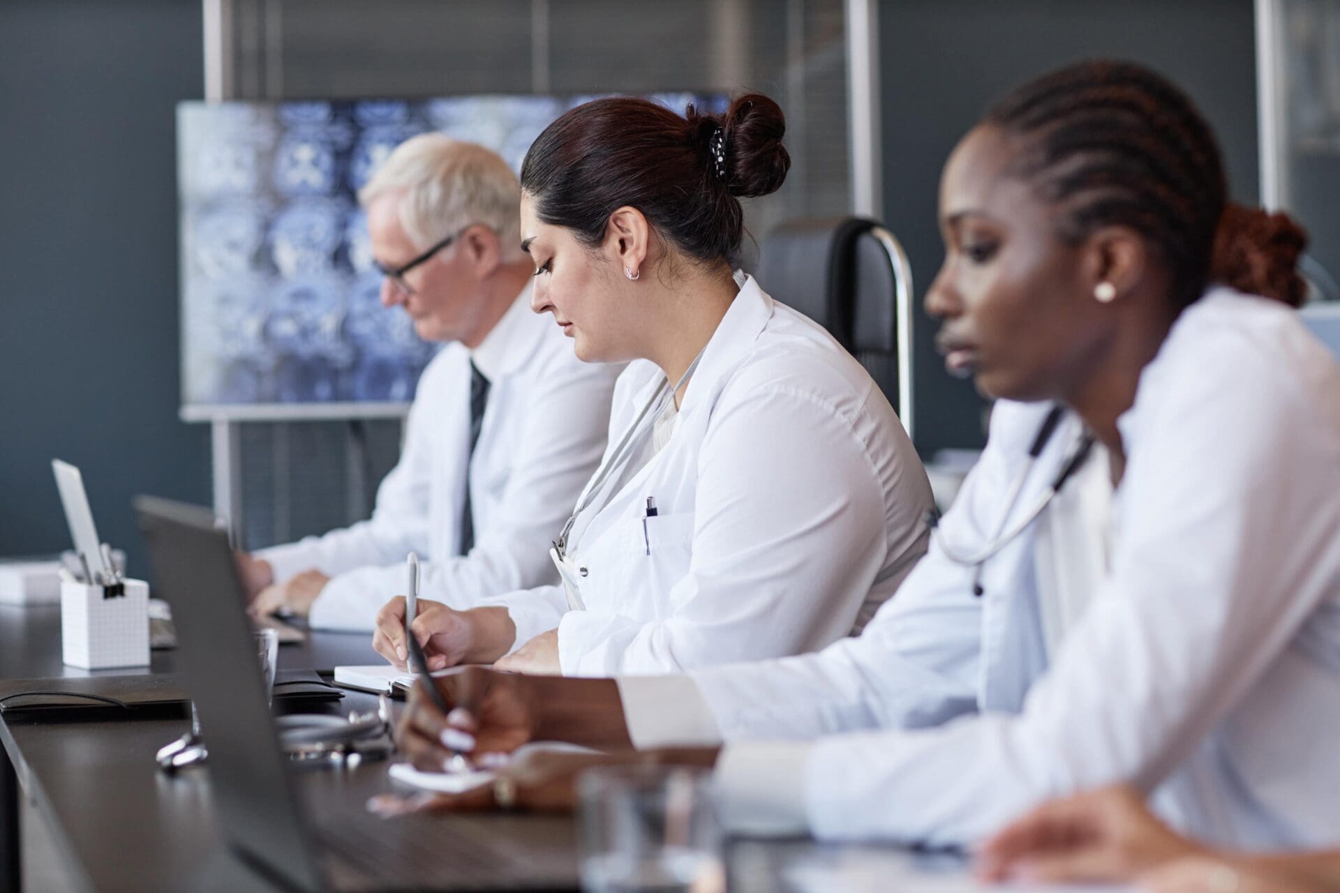 female doctor writing notes during colleagues spee 2024 12 26 23 53 54 utc 1 min