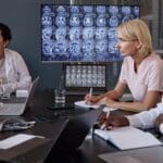 female neurologist writing notes while analyzing b 2024 12 26 23 49 51 utc min